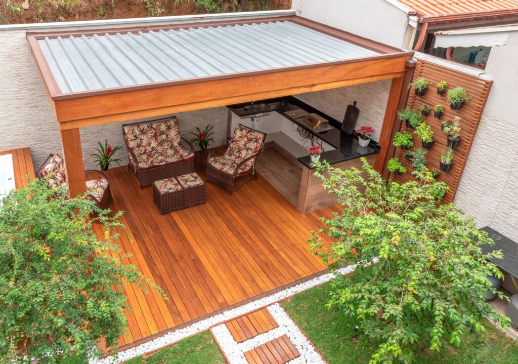 A small outdoor patio deck creating a modern outdoor aesthetic with a tin roof
