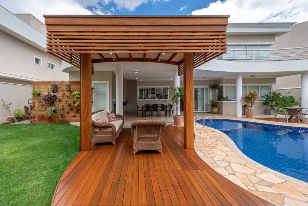 A contoured Ipe deck with a curved Roof next to a swimming pool
