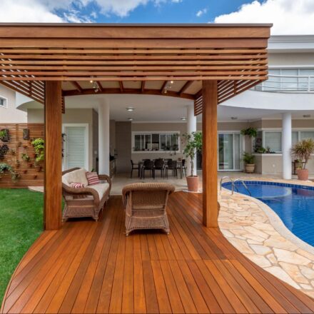 A contoured Ipe deck idea with a curved Roof next to a swimming pool
