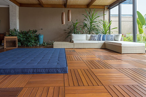 An indoor patio with 24x24 deck tiles from Lumber Plus as the floor