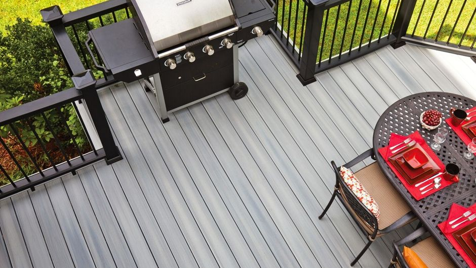 A grill and table on top of a deck after someone spent time building a deck in Florida