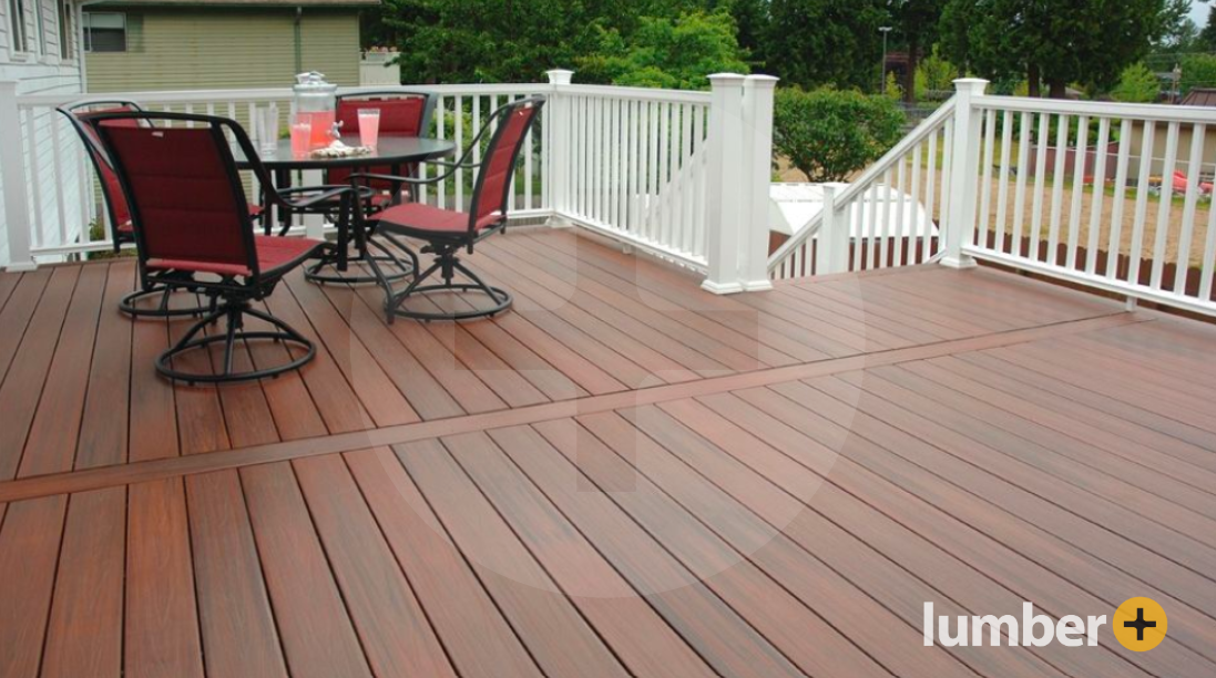 An outdoor deck with a dark gray decking material with white railing.