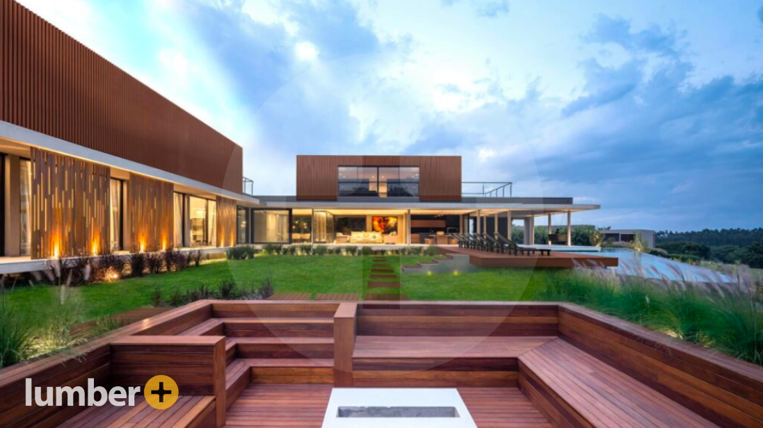 Luxury wood panel home with swimming pool and wooden step down deck.
