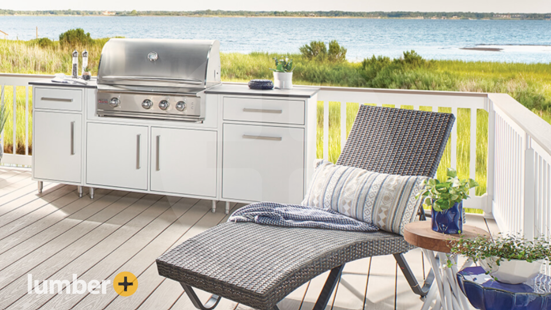 A light gray Wolf® PVC deck with a chair and grill overlooking a lake.