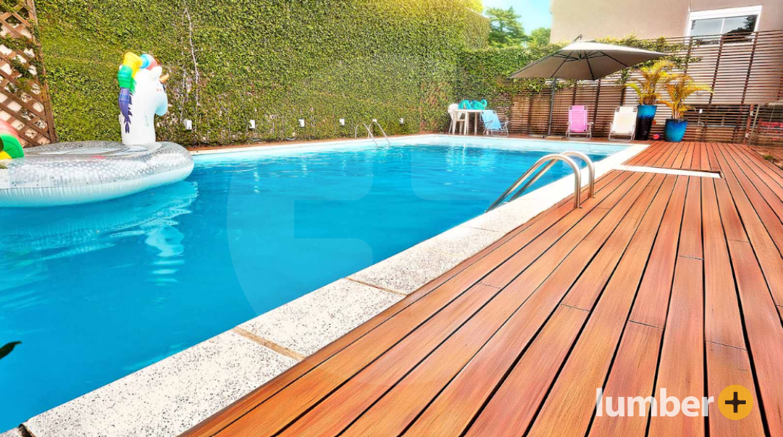 An Ipe pool deck with a large privacy fence. 