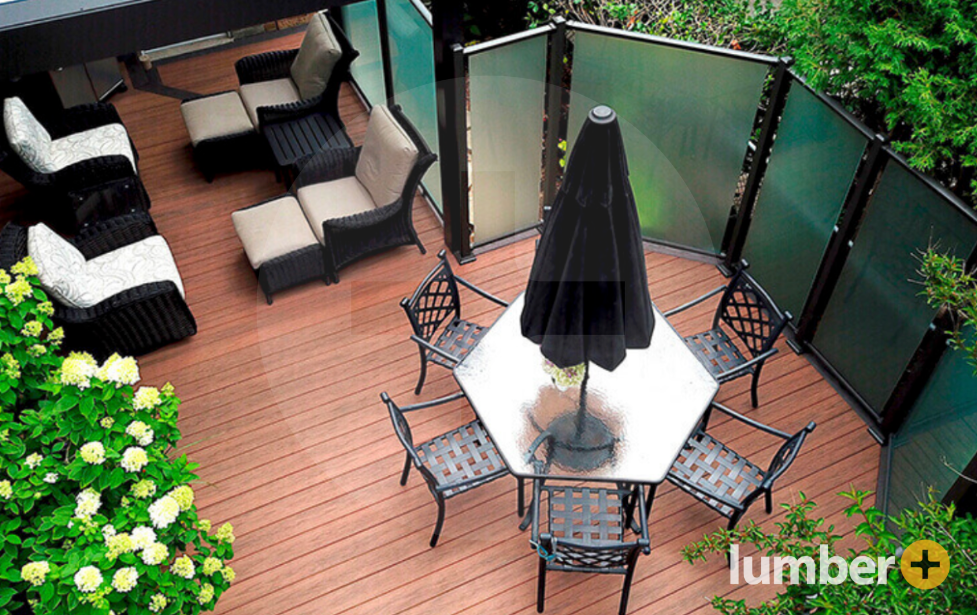 Brown Tiva™ decking with an outdoor dining table, deck furniture, and a privacy shield.