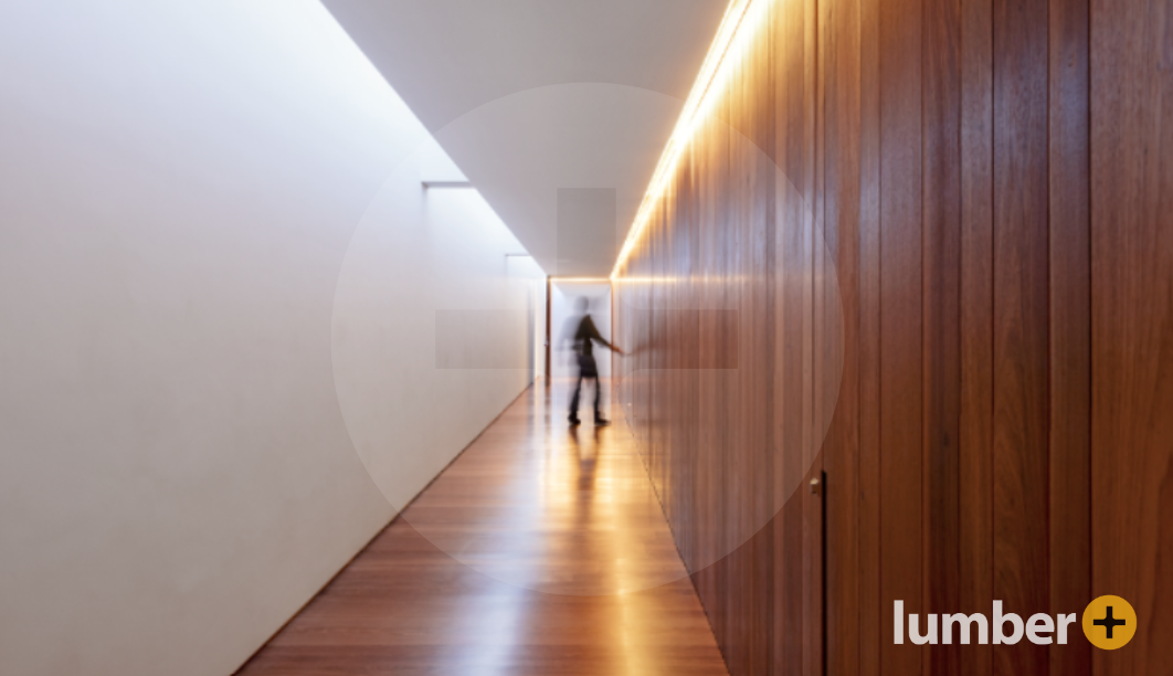 Wood panels line the hallway of a workspace.