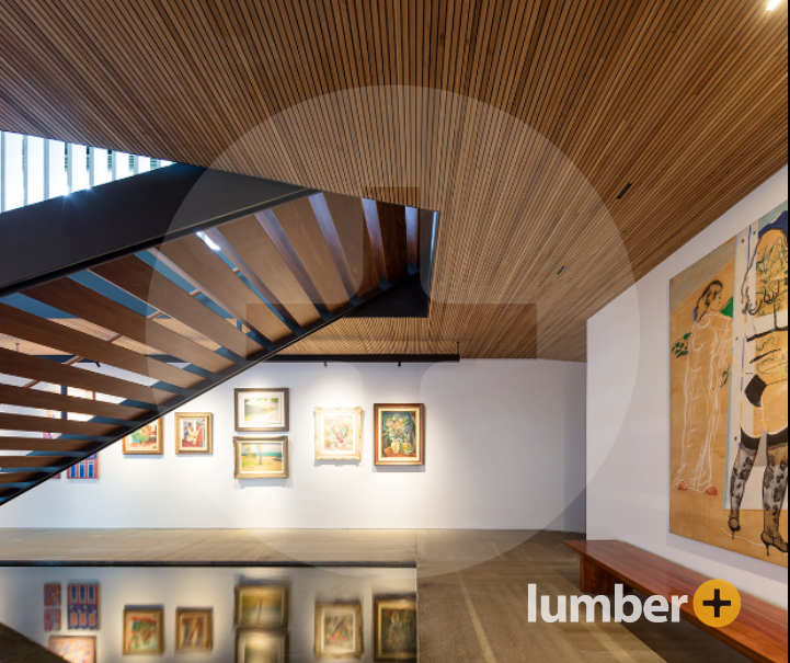 An art gallery with wooden panels on the ceiling. 