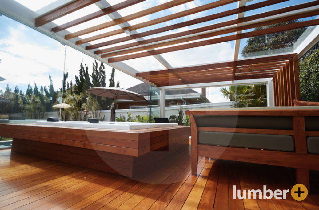 Glass skylight wooden deck with a hot tub and seating room.