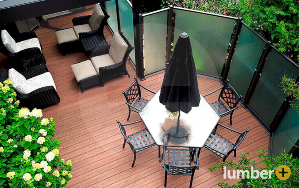 Brown Tiva™ decking with an outdoor dining table, deck furniture, and a privacy shield