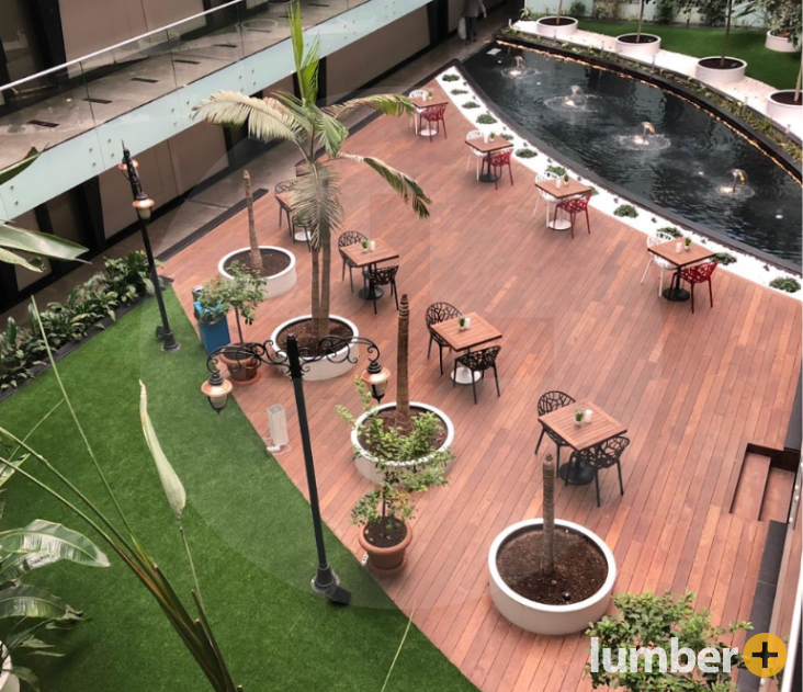 simple floating deck in a courtyard near water and grass