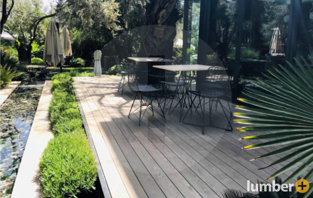 outdoor dining area sitting on a floating deck next to water features