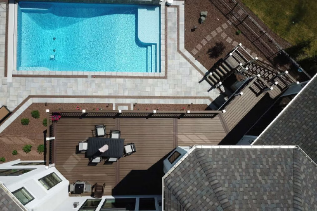 Trex pool deck in Spiced Rum with a cocktail rail, designed for poolside entertaining and relaxation.