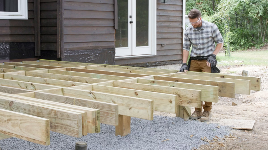 An image of a contractor installing deck framing for Trex.