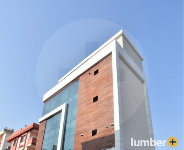 Thermally Modified Wood in the color Ash on the exterior of a large building.