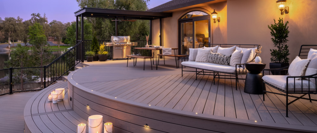 A Trex composite deck patio lit at night, staged for entertaining guests.