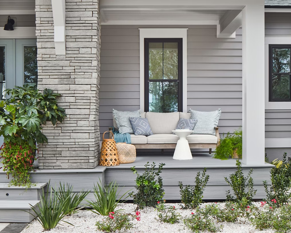 Raised patio with Rainier decking and matching fascia, complete with a cozy sitting area for lounging.