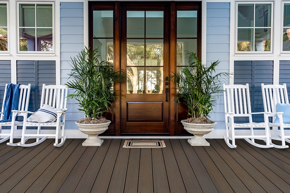 Patio with Coastal Bluff decking and white rocking chairs for a cozy, contrasting look.