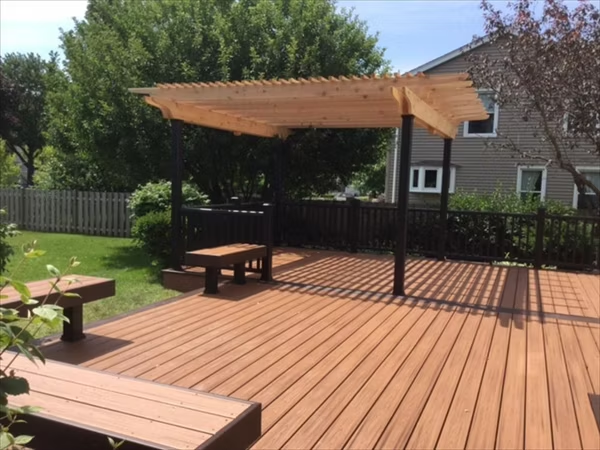 Trex patio deck in light brown with a pergola, perfect for shaded outdoor living.