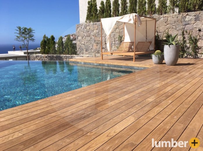Poolside deck built with Thermowood Ash, featuring smooth, warm-toned boards beside clear water.
