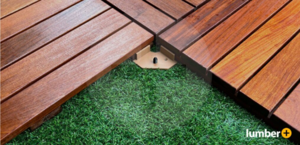 An image showing a close-up of wood deck tiles installed over artificial turf with hidden fasteners.